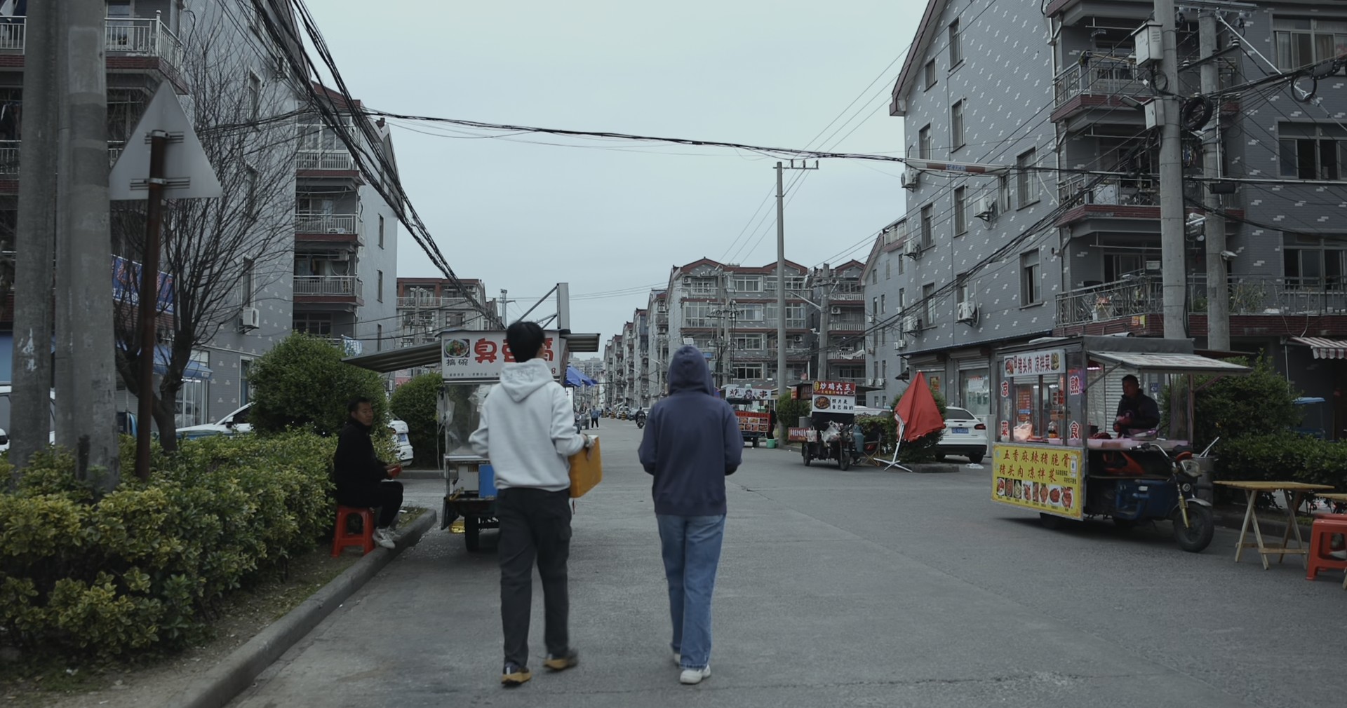 Two girls walking along a village street
